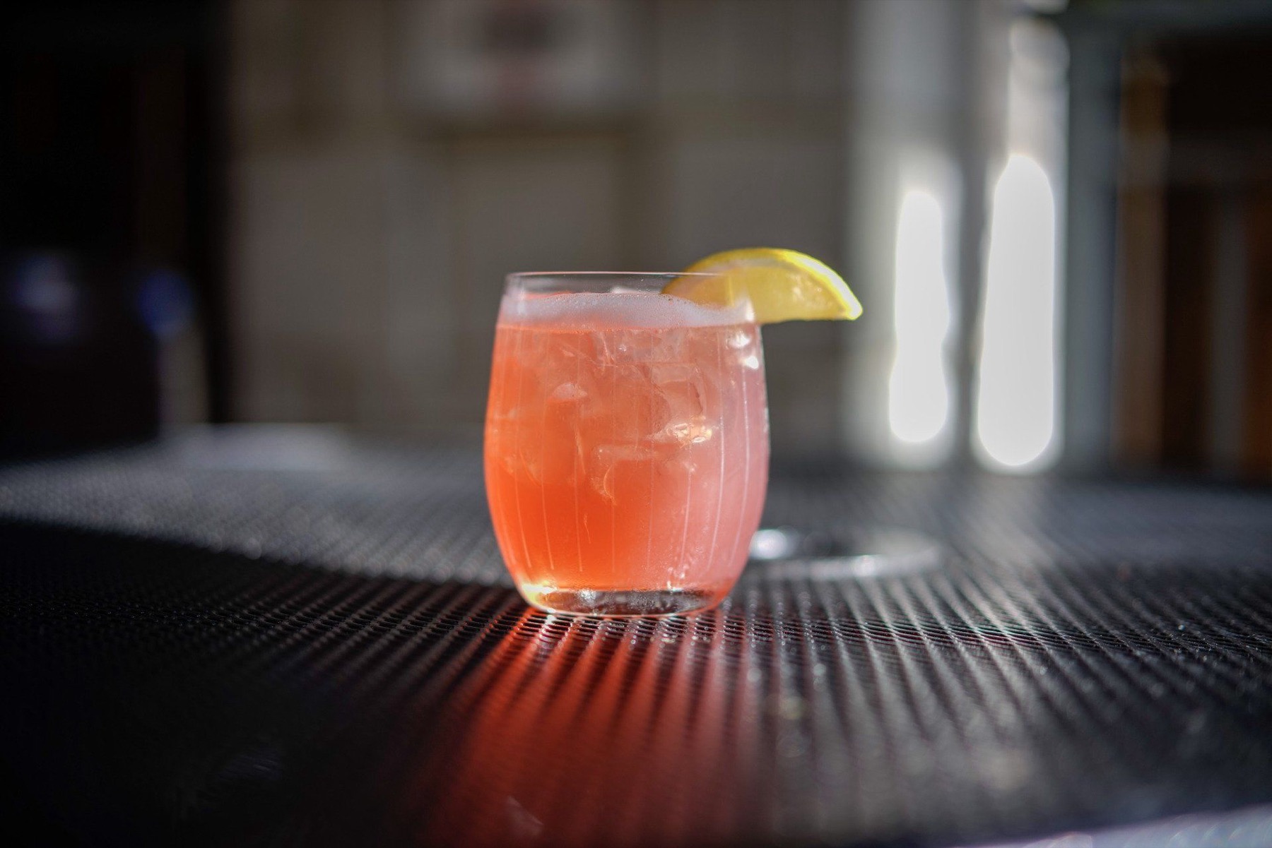 A ruby cocktail glowing in the evening light