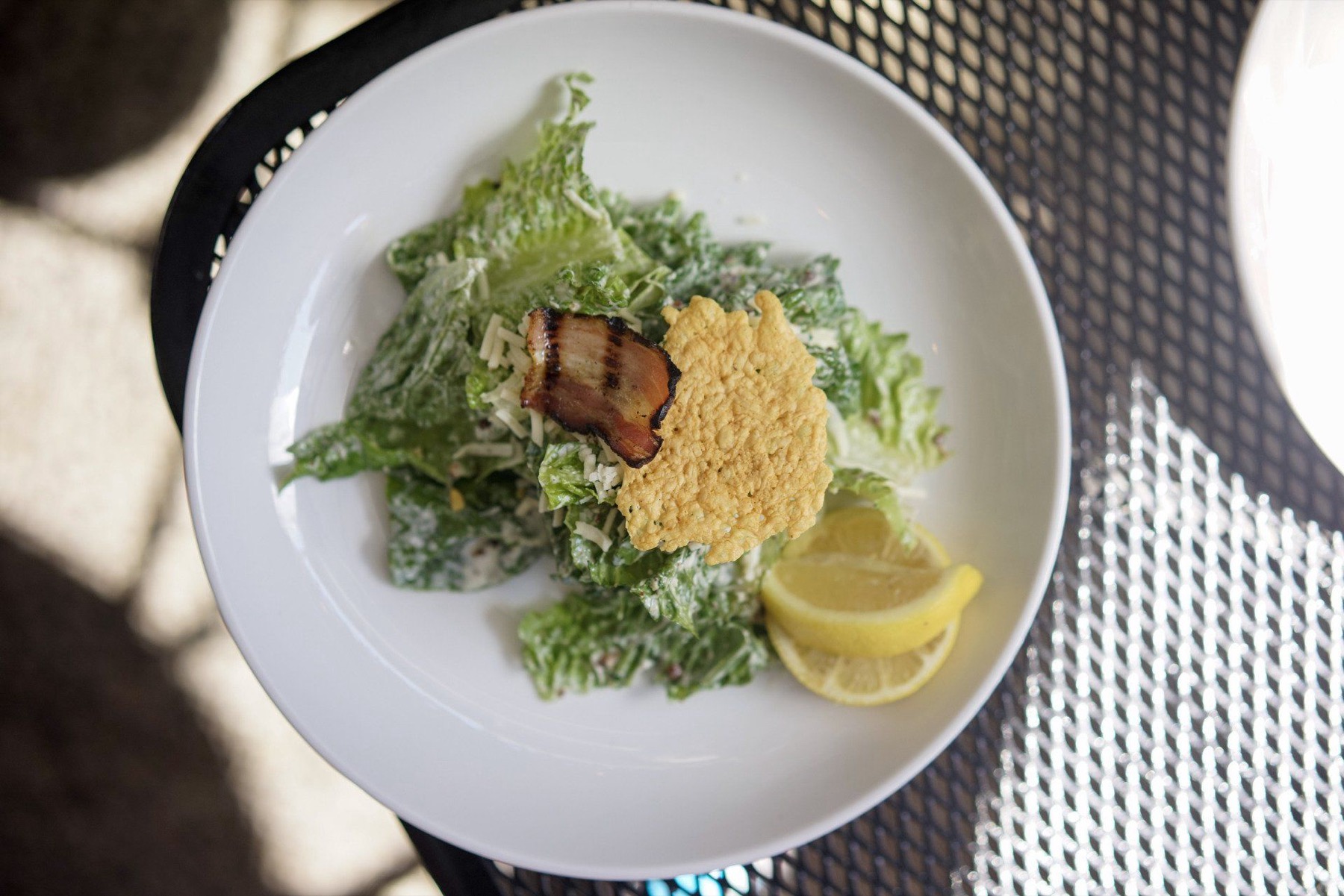 Waldo’s classic Caesar salad with grilled pancetta, a parmesan crisp and lemon, served on the patio