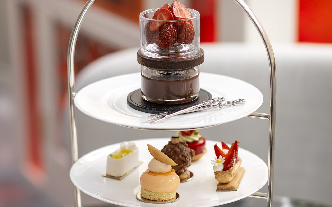 A two-tier stand of petits fours and chocolate-dipped strawberries