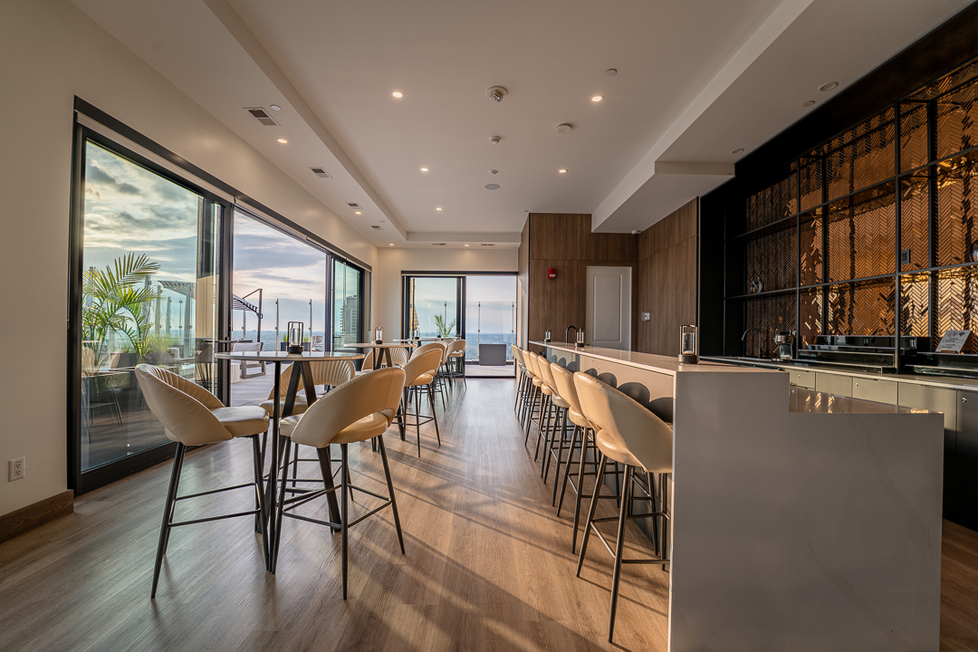 Light-filled lounge bar opening onto the rooftop terrace