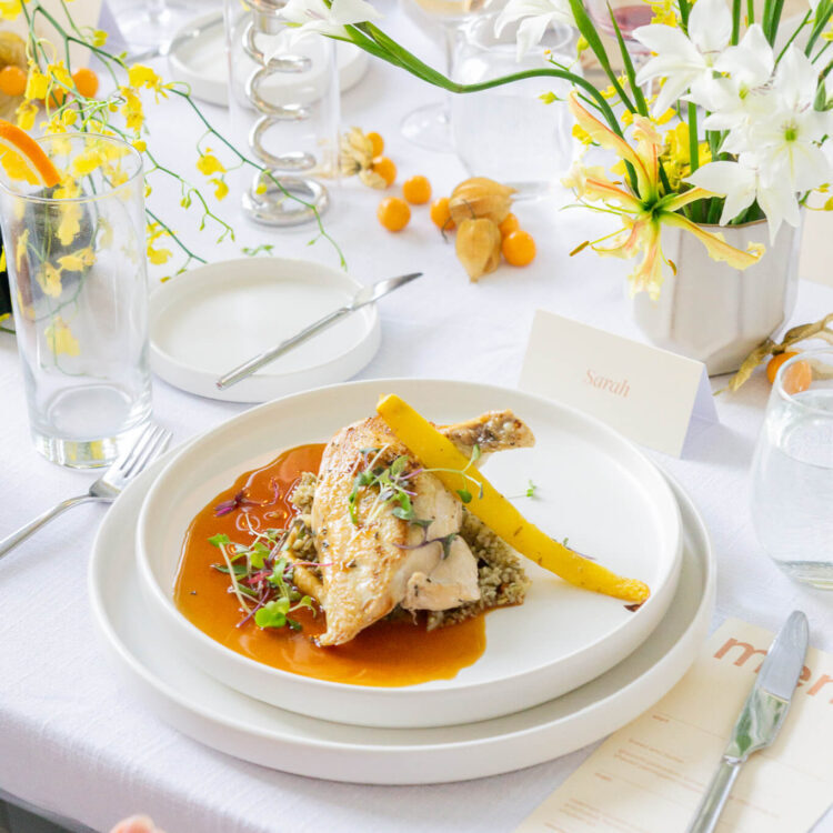 Plated chicken with pan jus at a private dinner