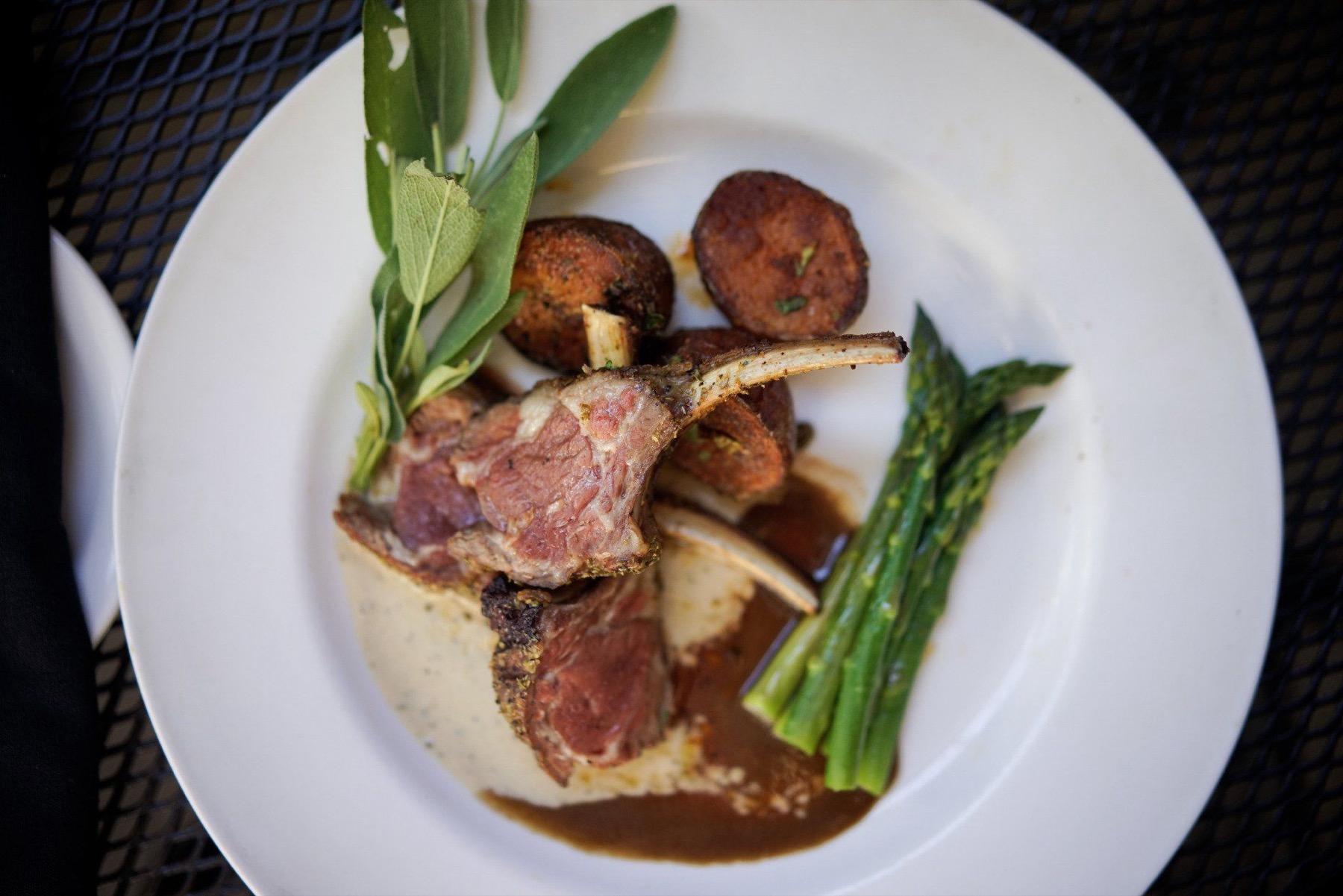 Rack of lamb plated with asparagus and potato croquettes