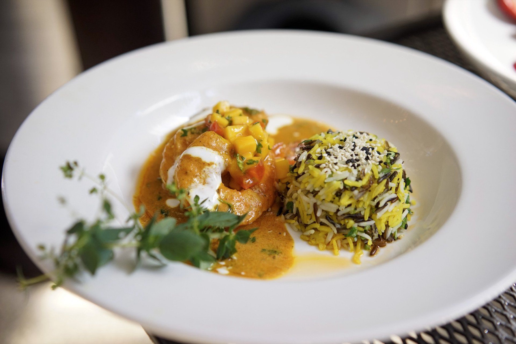 Seafood in a saffron sauce with mango salsa and wild rice
