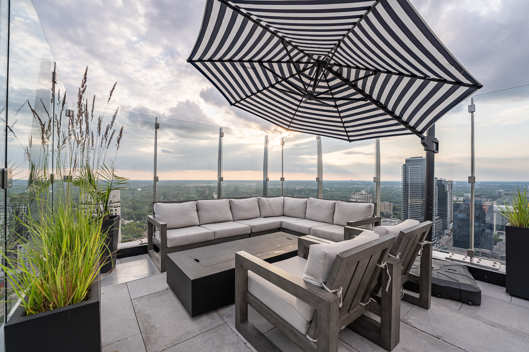 The Sky Lounge rooftop terrace with lounge seating, a striped umbrella and views over London